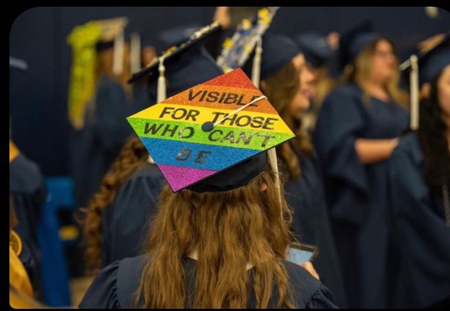 A rainbow graduation cap which reads "visible for those who can't be"
